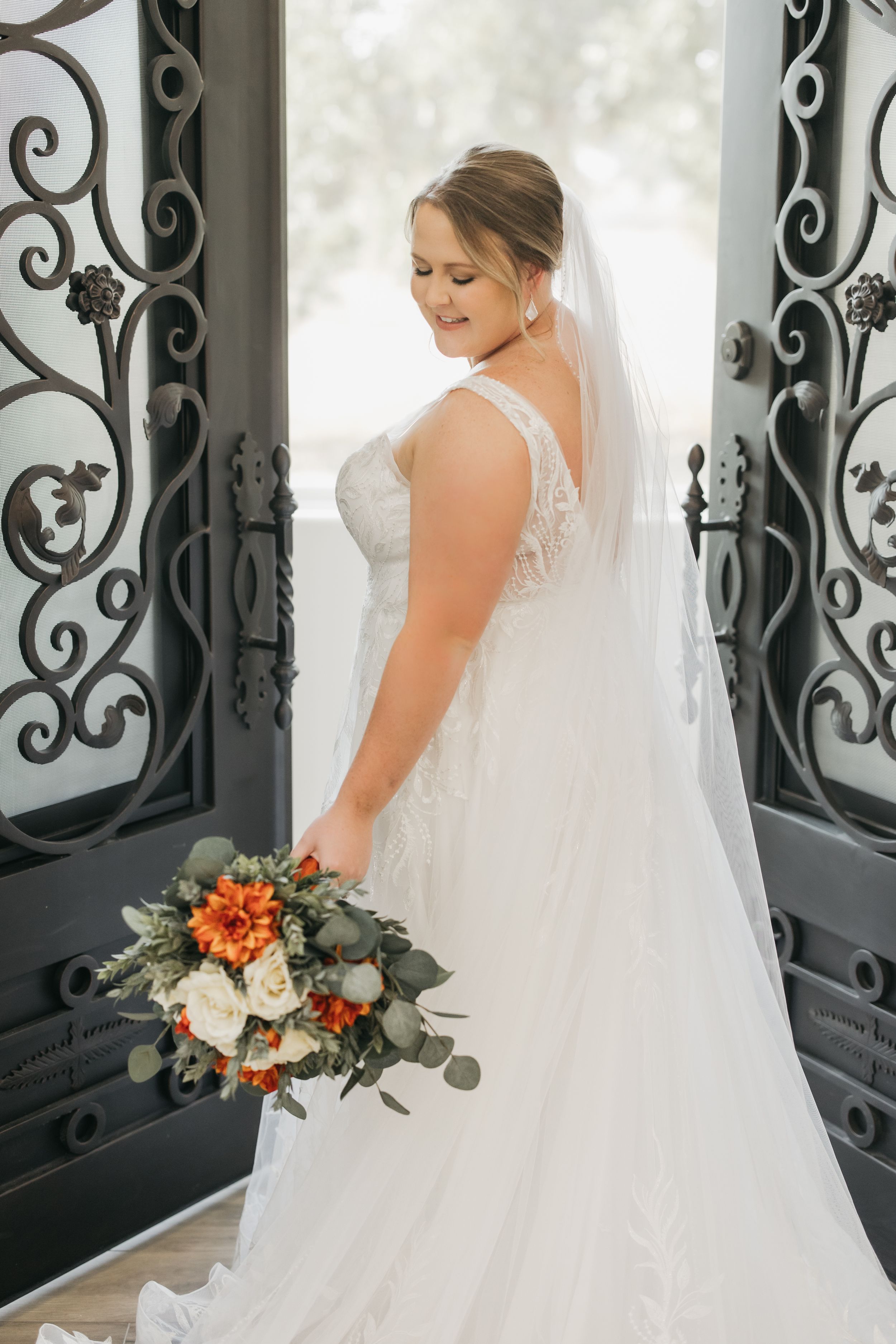 Bride walking through the doors at the start of her wedding ceremony in Temple, Texas