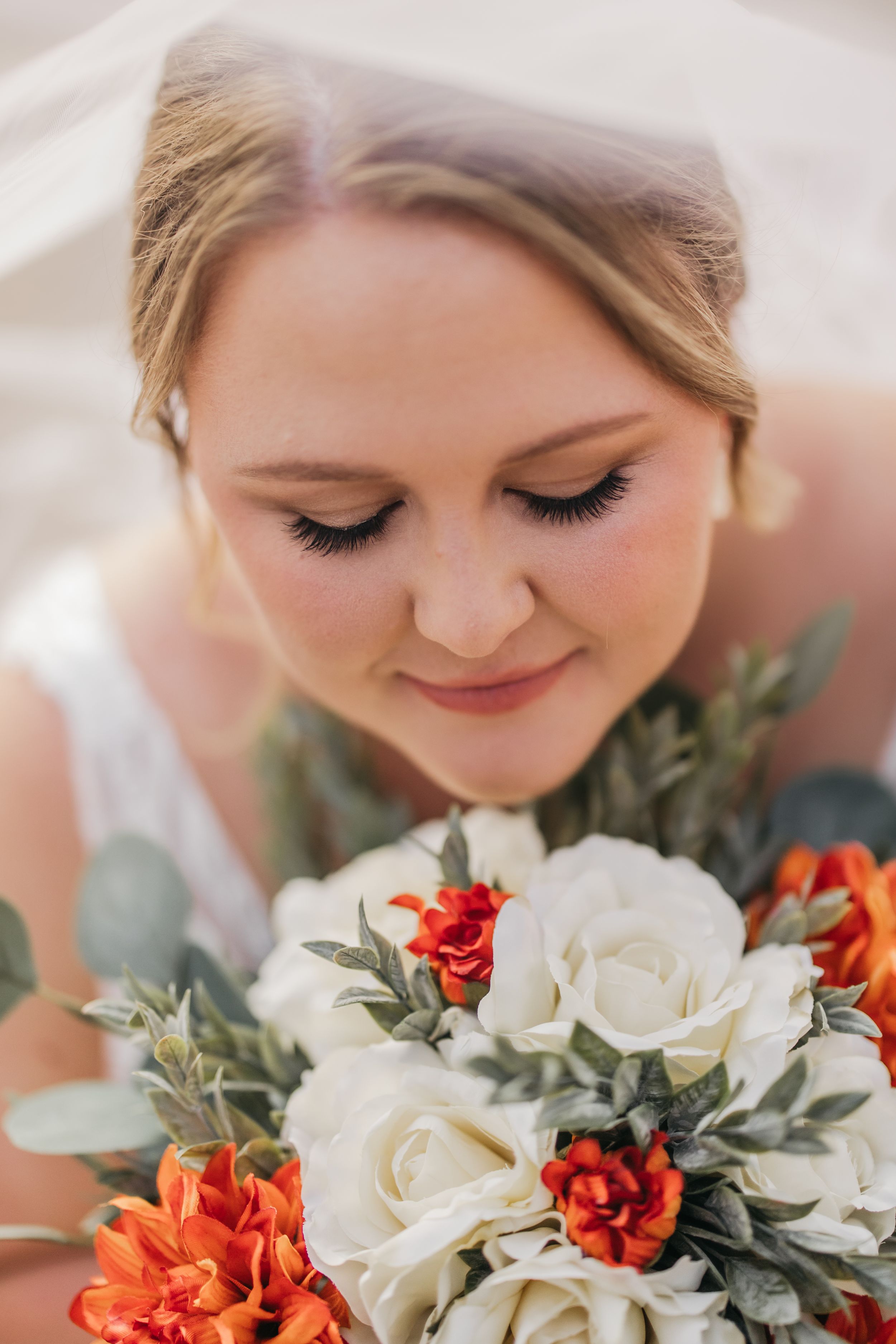 Under veil portrait of bride during wedding photo session in Temple, Texas