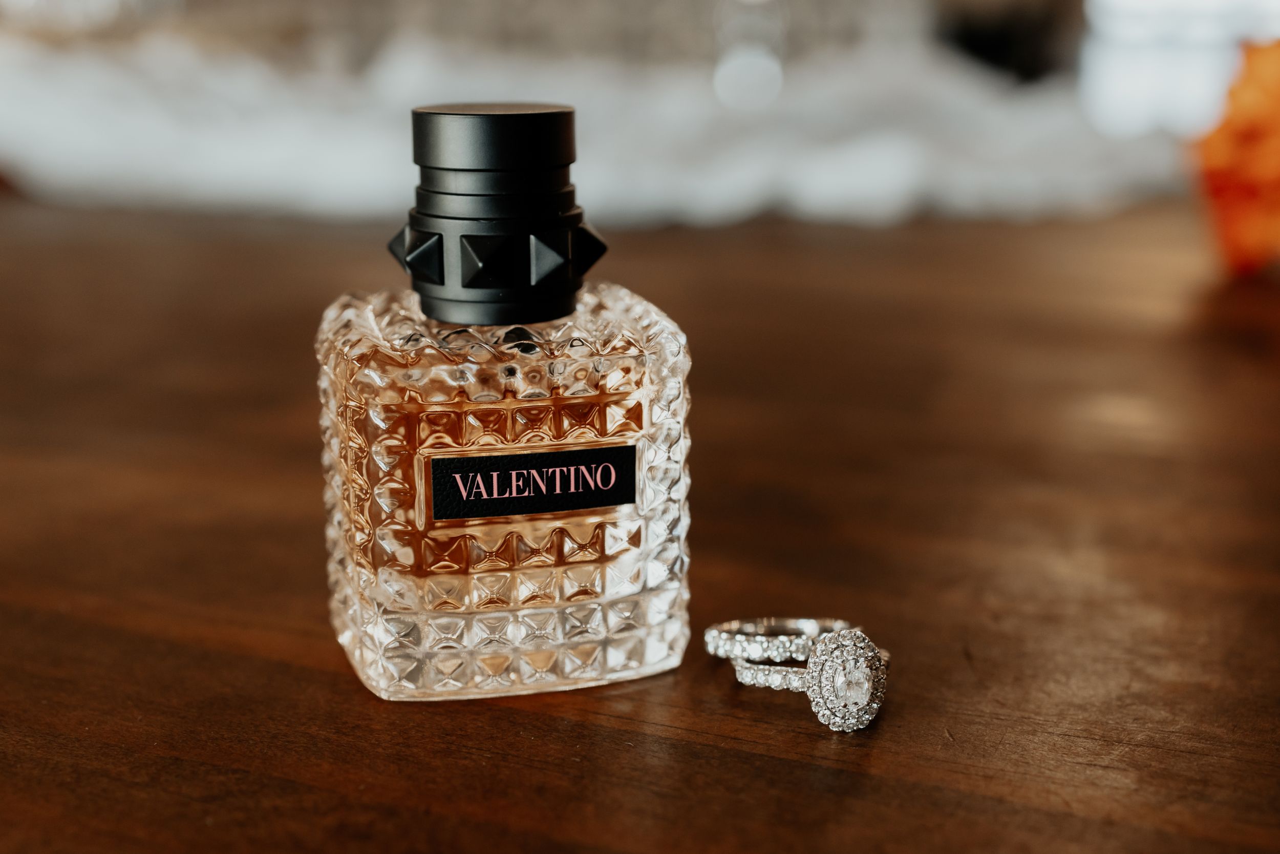 Wedding detail shot of perfume bottle and rings during a wedding in Belton, Texas