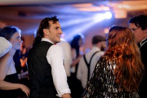 guest dancing at wedding day against the lights