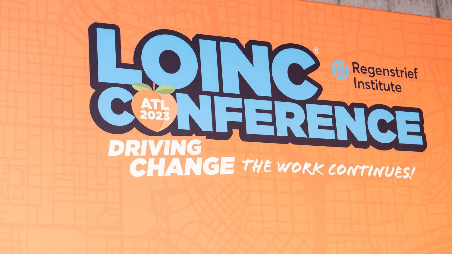 LOINC Conference banner with tagline 'Driving Change' on orange background.