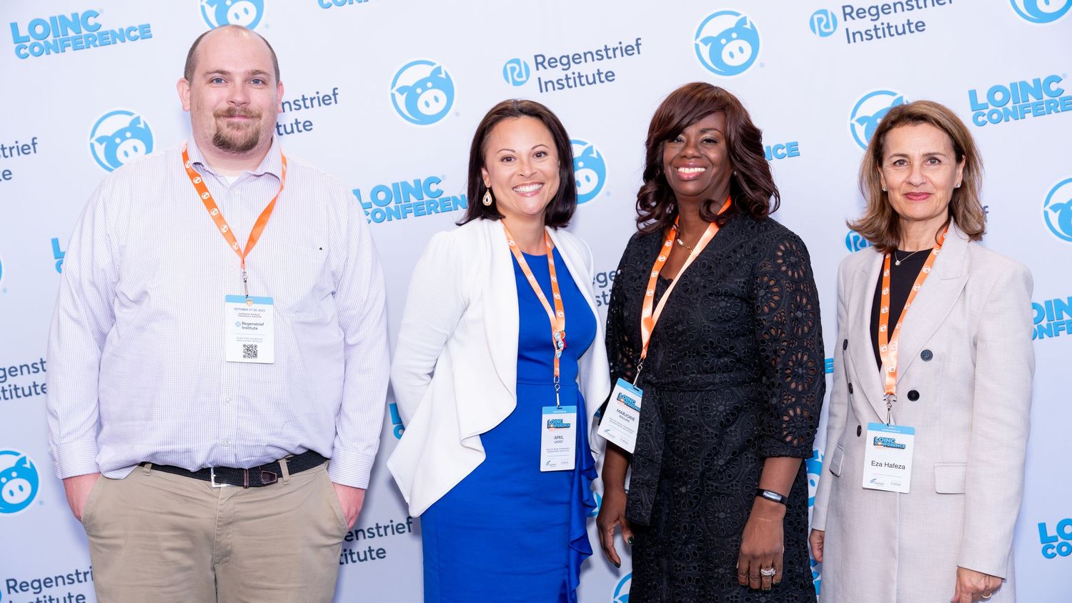 Four conference attendees pose together at the LOINC Conference.