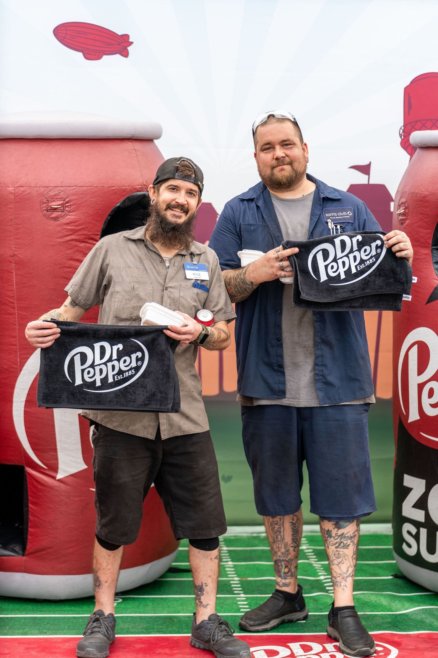 A series of people showing off their leg tattoos while posing against a red and white football-themed backdrop.