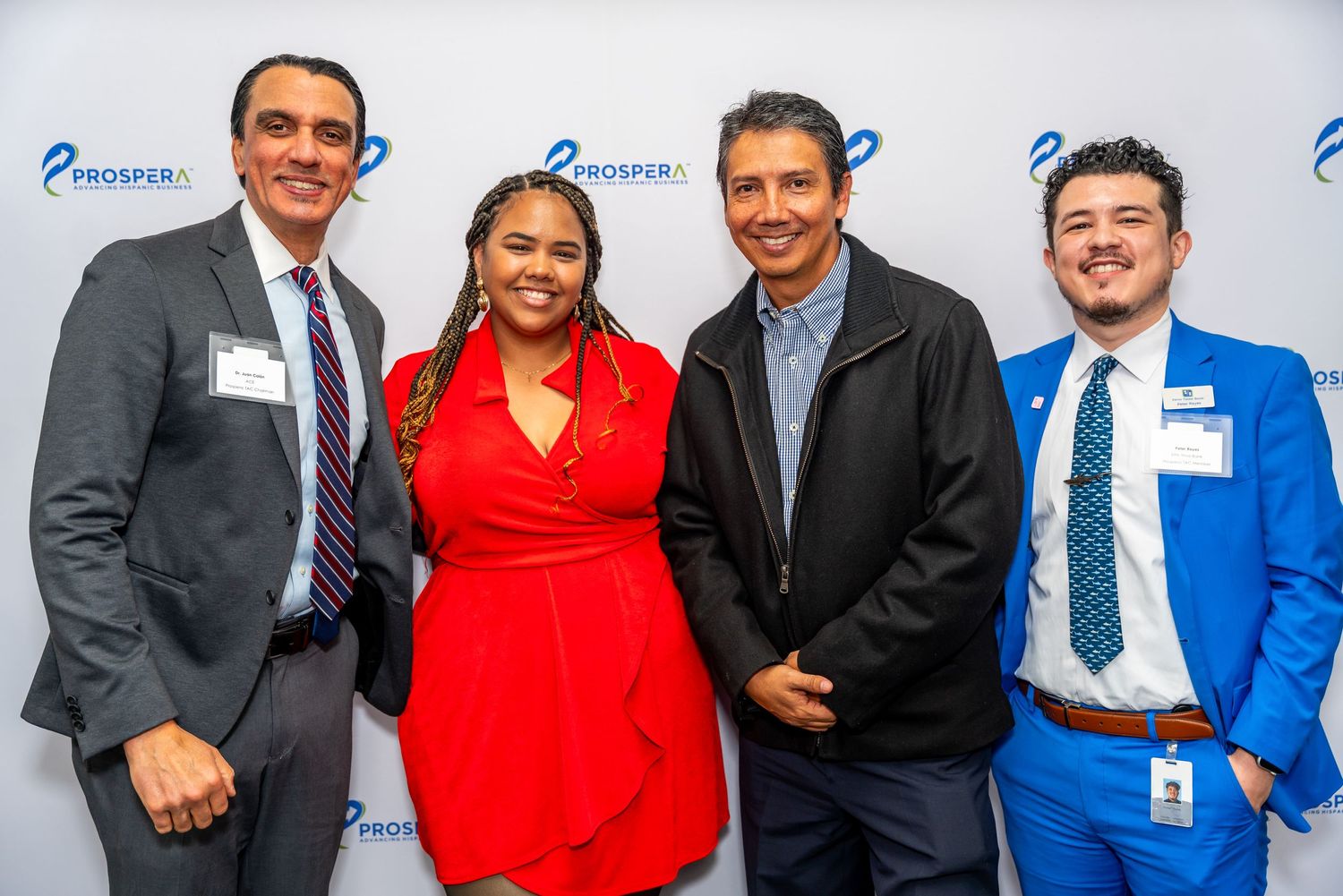 Group of professionals in business attire pose together at a corporate event with Enverus logos in background.