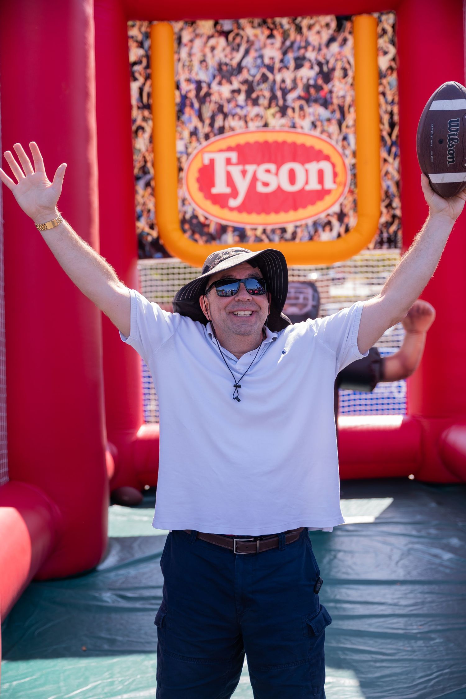 Enthusiastic person celebrating at Tyson branded promotional event display.