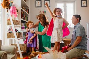 In-home Family photoshoot in orlando with kids playing dress up in a colorful children's room.