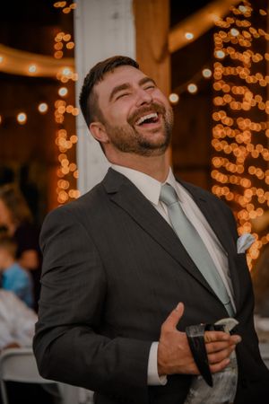 Wedding photography groom laughing