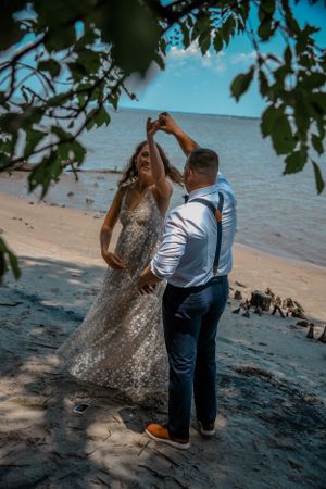 Bride and groom dancing on the beach