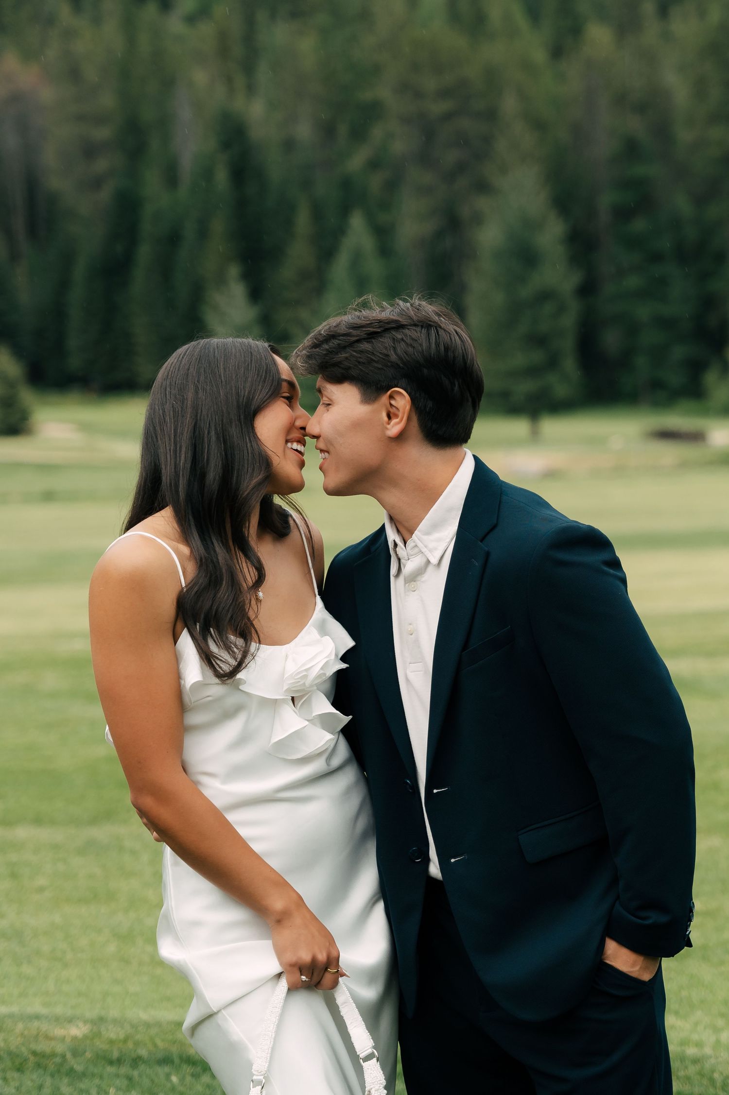 photo of the bride and groom while the groom is holding the bride's dress