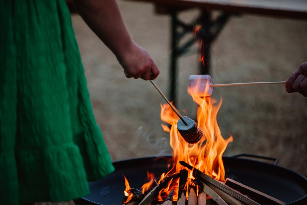 Fire pit and Marshmallows at a wedding at Fonthill Estate near Wiltshire. A small intimate wedding barn near Andover.