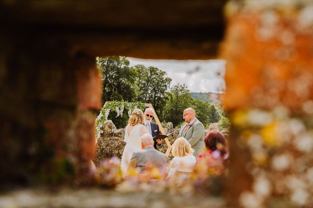 Small intimate barn wedding in Salisbury at Fonthill Estate Deer Park Barn. With Floral hexagon archway