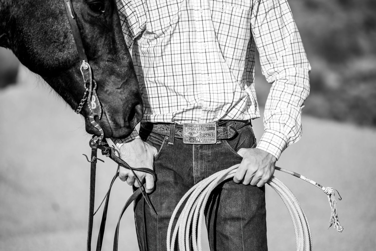 Black and white image of horse handlers showing proper lead rope techniques.
