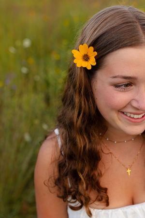 Summer portrait featuring orange flower accessory and delicate jewelry. Senior photo session. Lake Geneva Wisconsin Photographer