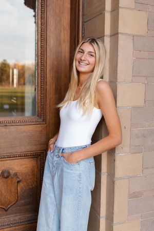 Light casual outfit styled against brick building entrance. Senior photo session. Lake Geneva Wisconsin Photographer