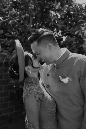 Romantic couple sharing an intimate moment against a lush garden backdrop.