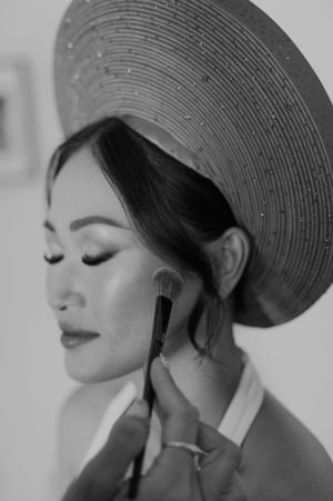 Artistic black and white profile portraits of a woman wearing a stylish hat.