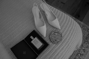 A series of black and white photographs showing different angles of white sneakers on a textured background.