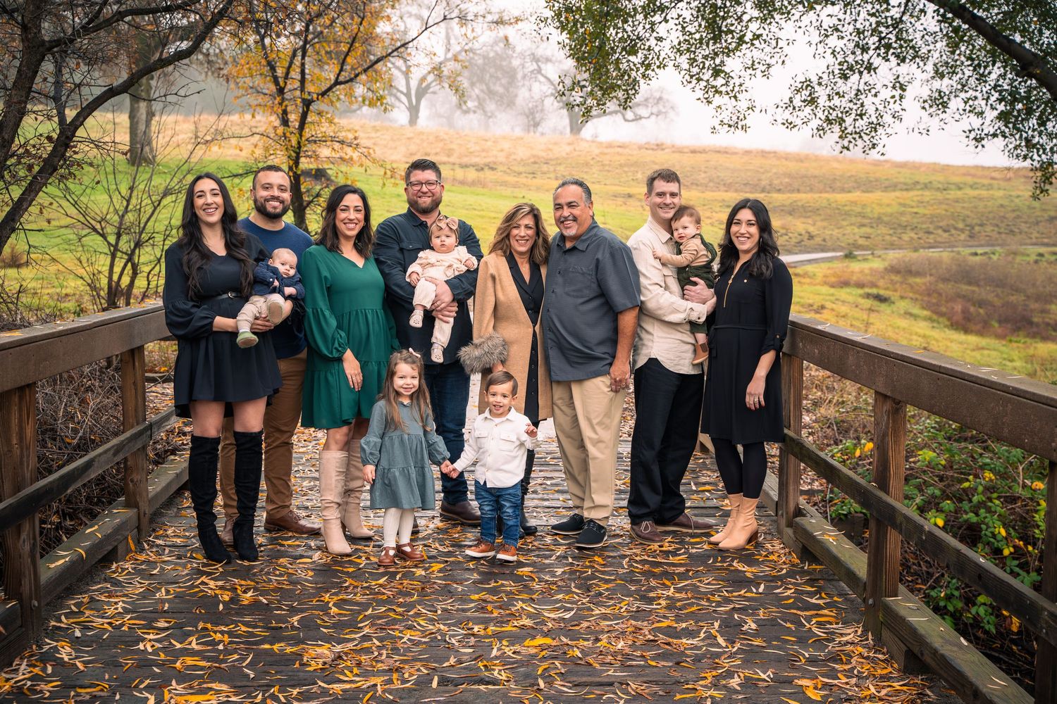 Family group photos taken outdoors during autumn with fall foliage in background.