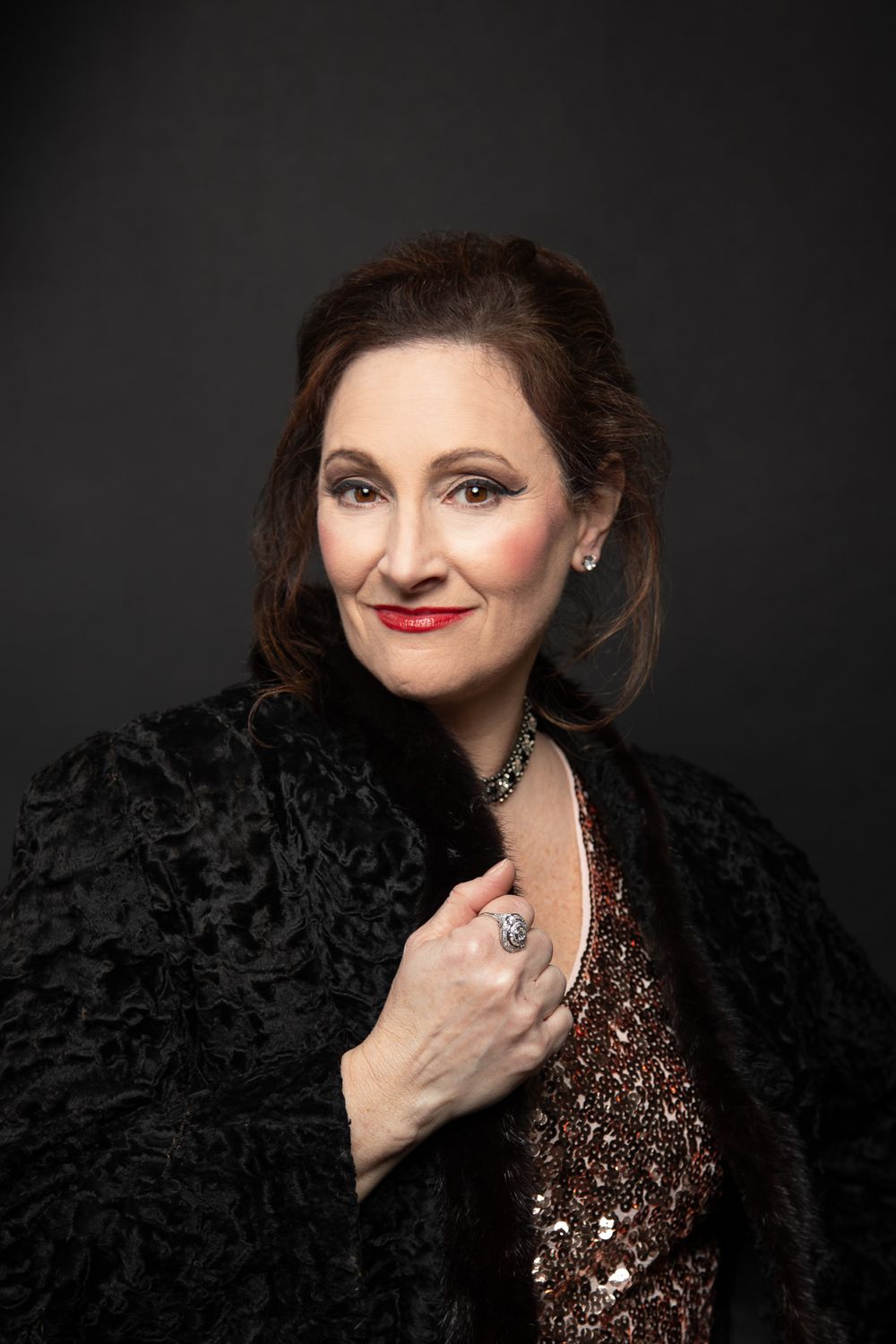 Vintage style glamour portrait of woman with sequin dress and fur coat
