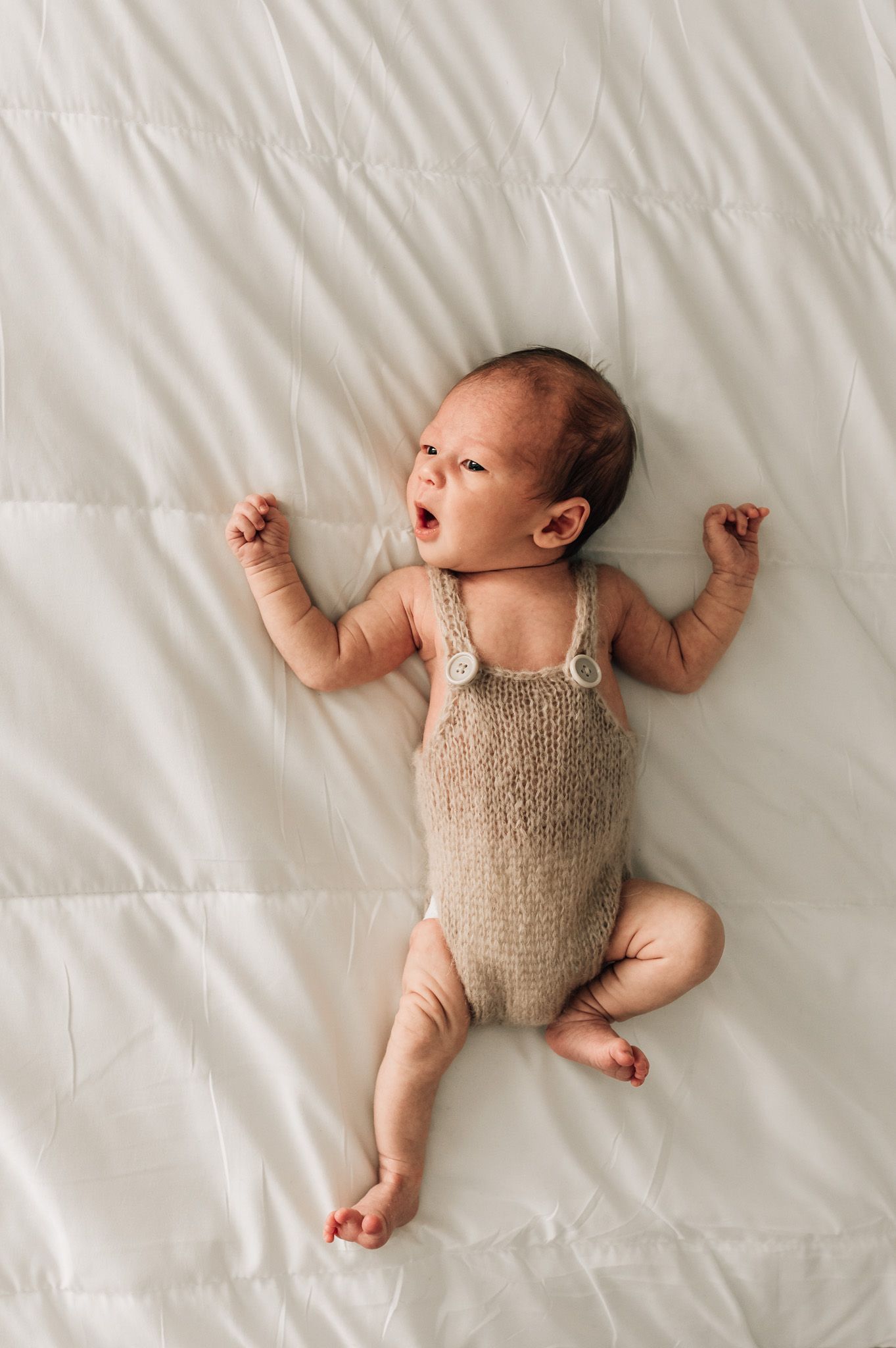 newborn-on-bed-photoshoot