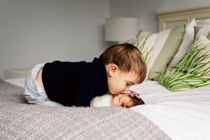 big-brother-kissing-new-baby-girl