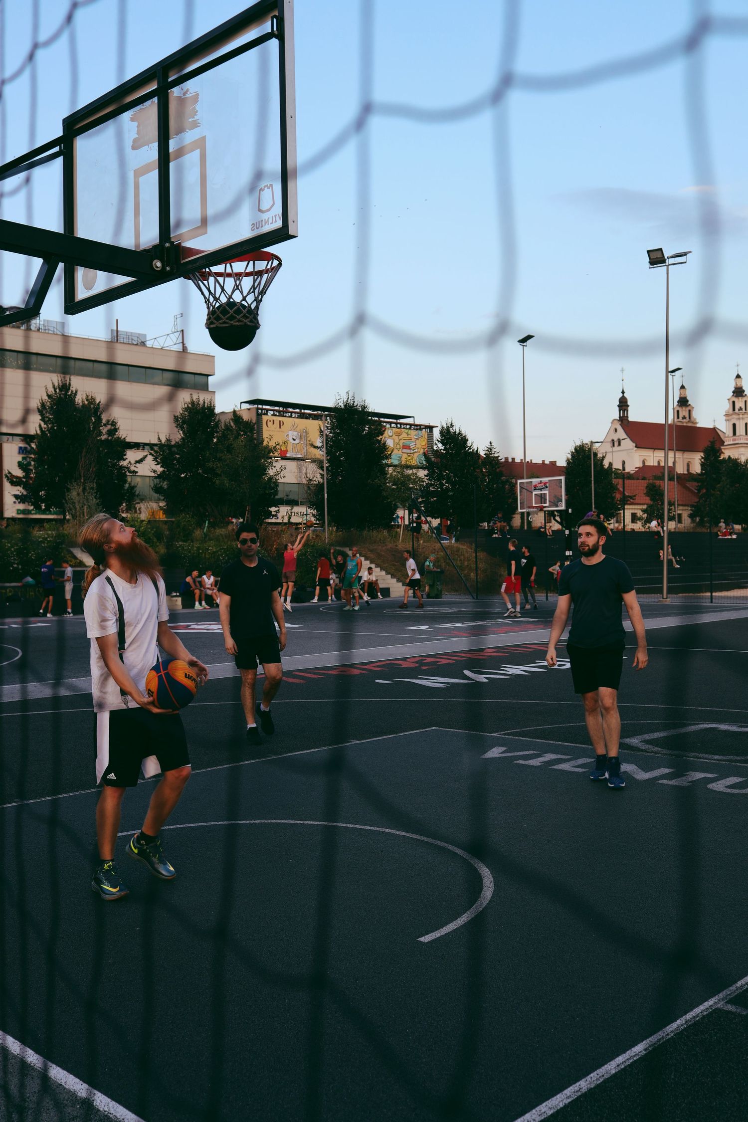 Lithuanians play basketball not far from CUP in Vilnius. The ball froze in the ring.