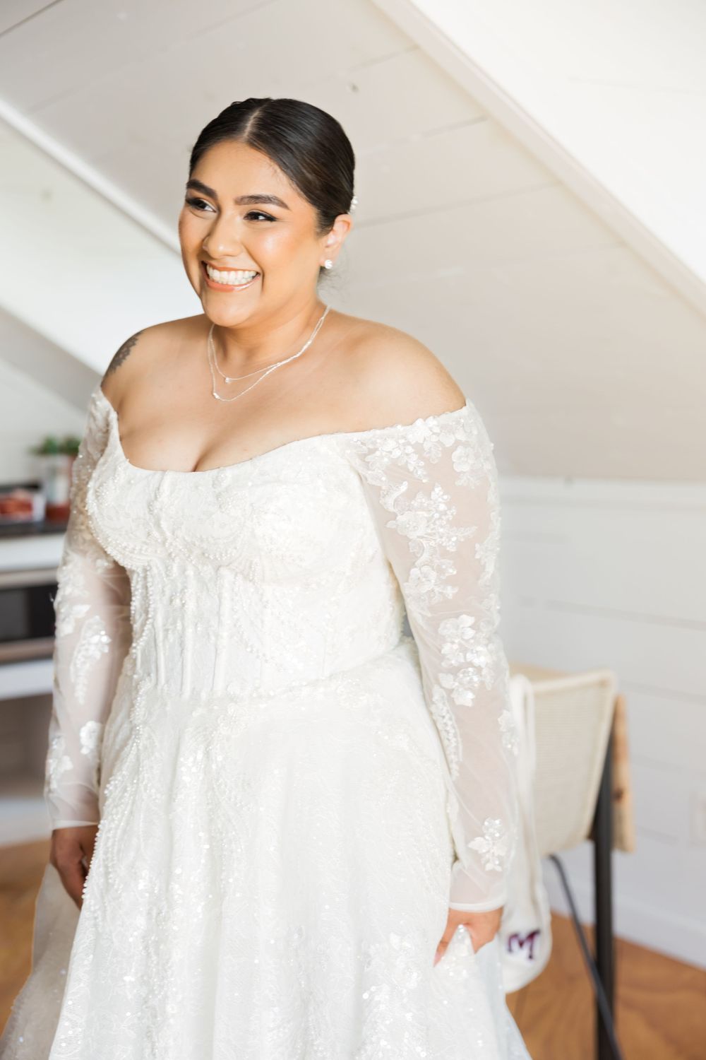 A beautiful off-shoulder white lace wedding dress with sheer sleeves shown in a sequence of photos.