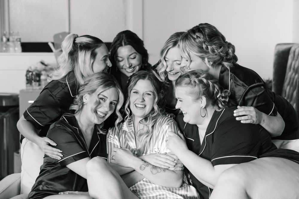 Black and white candid photos showing joyful moments during wedding preparations.