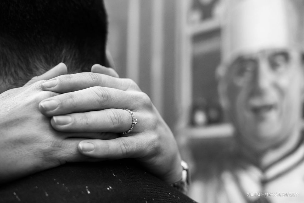 Close-up shot of hands with rings in black and white photography.