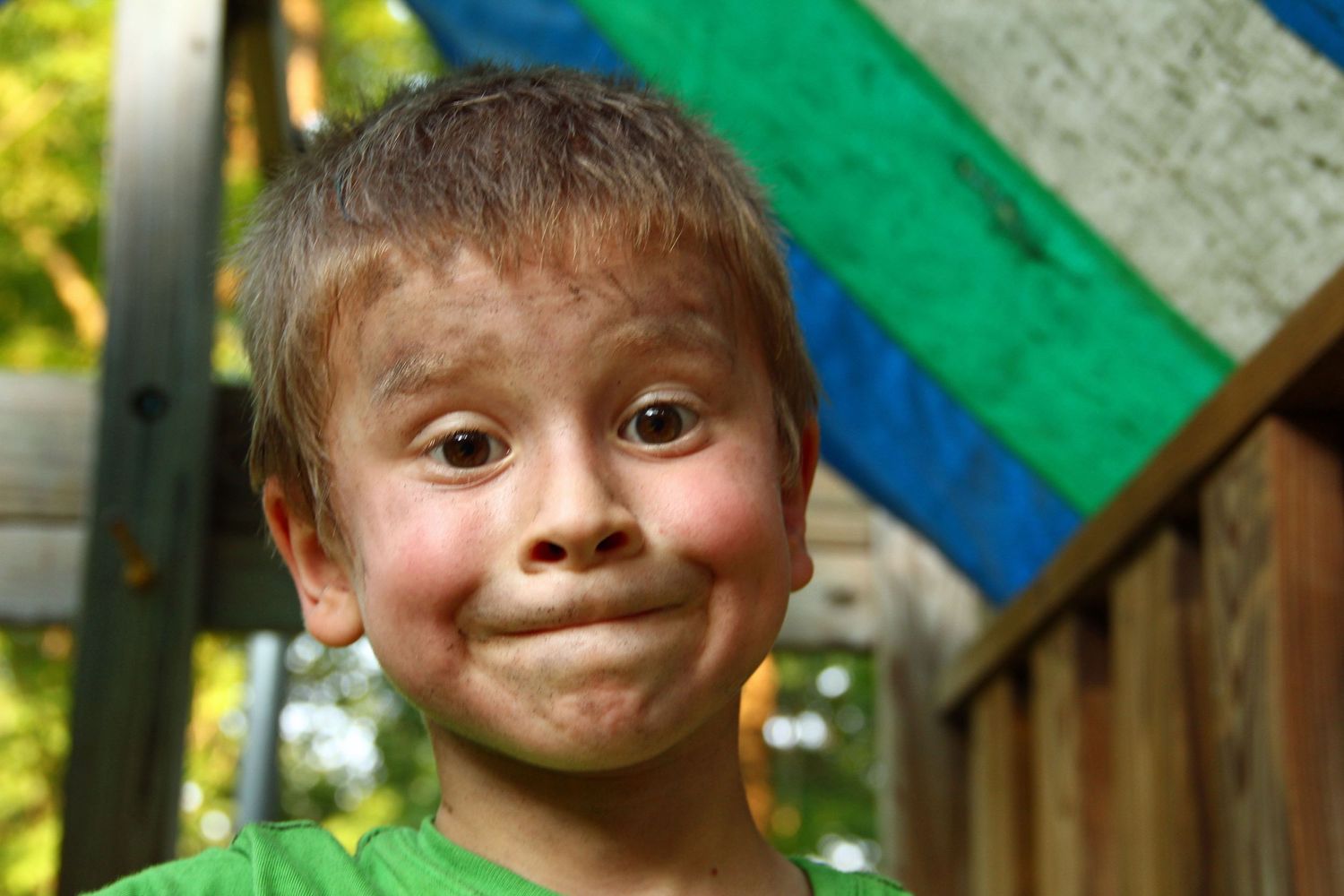 a young boy make a silly face