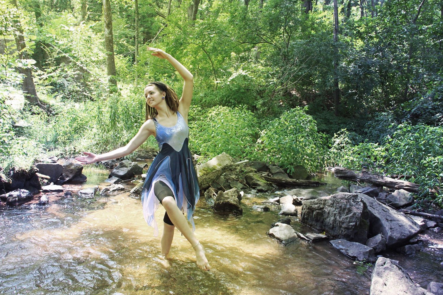 a ballerina poses in the water