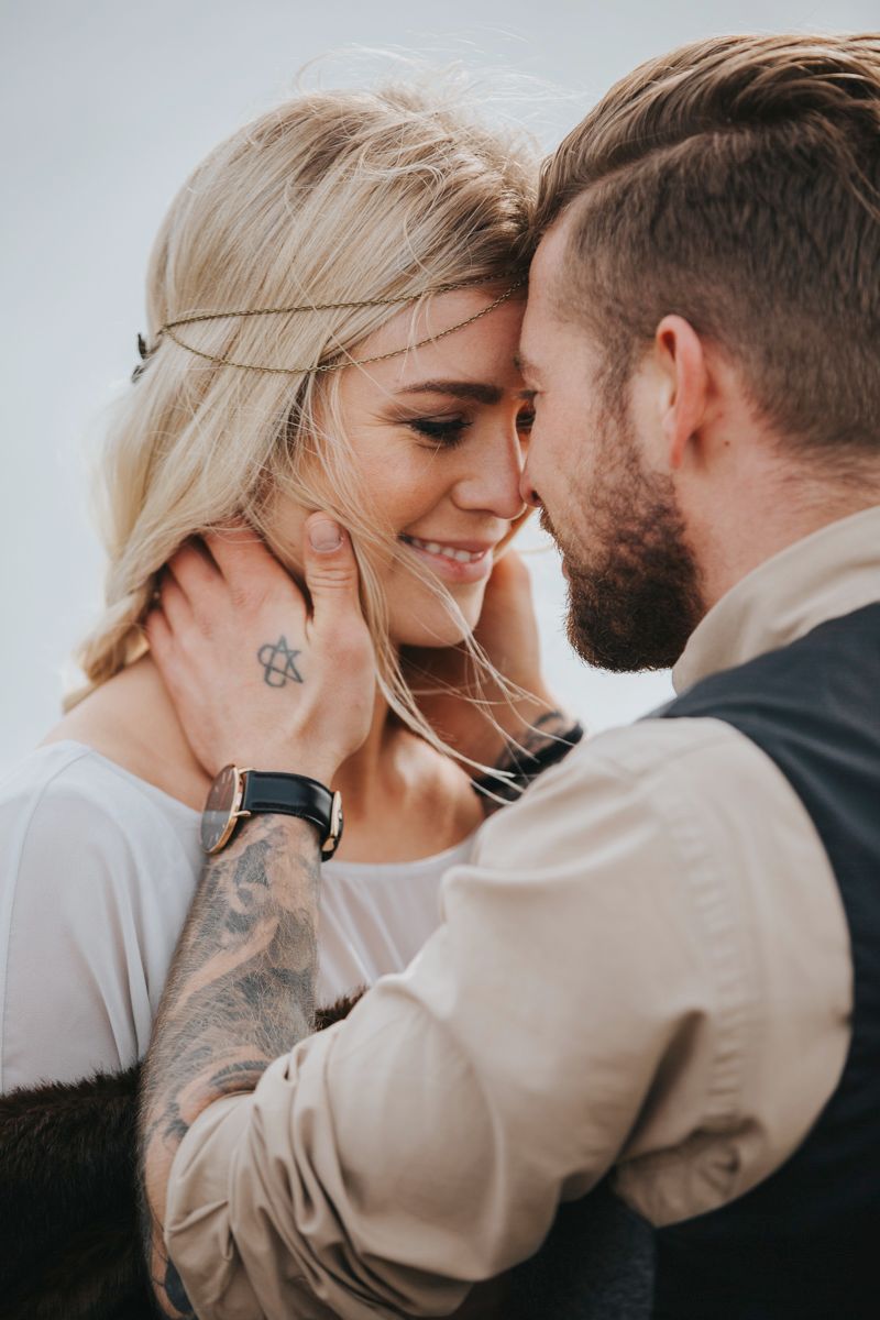 Close-up wedding portrait showing tender intimate moment outdoors.