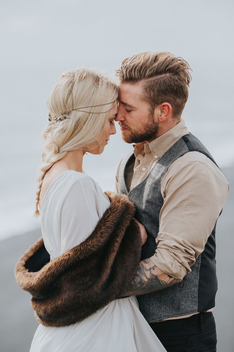 Romantic wedding photo showing couple in vintage-inspired attire.
