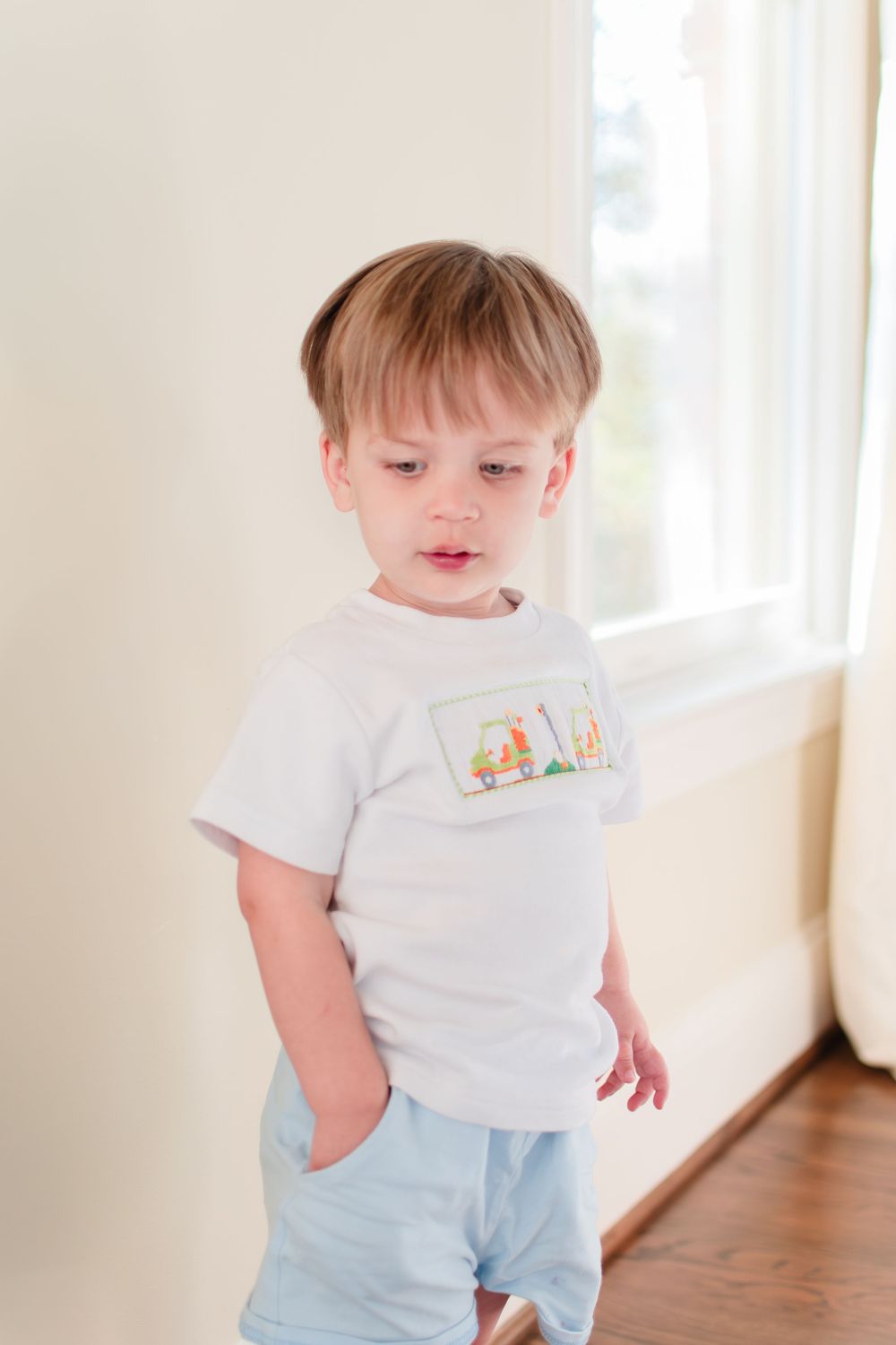 This young toddler boy enjoys keeping his hand in his pocket.