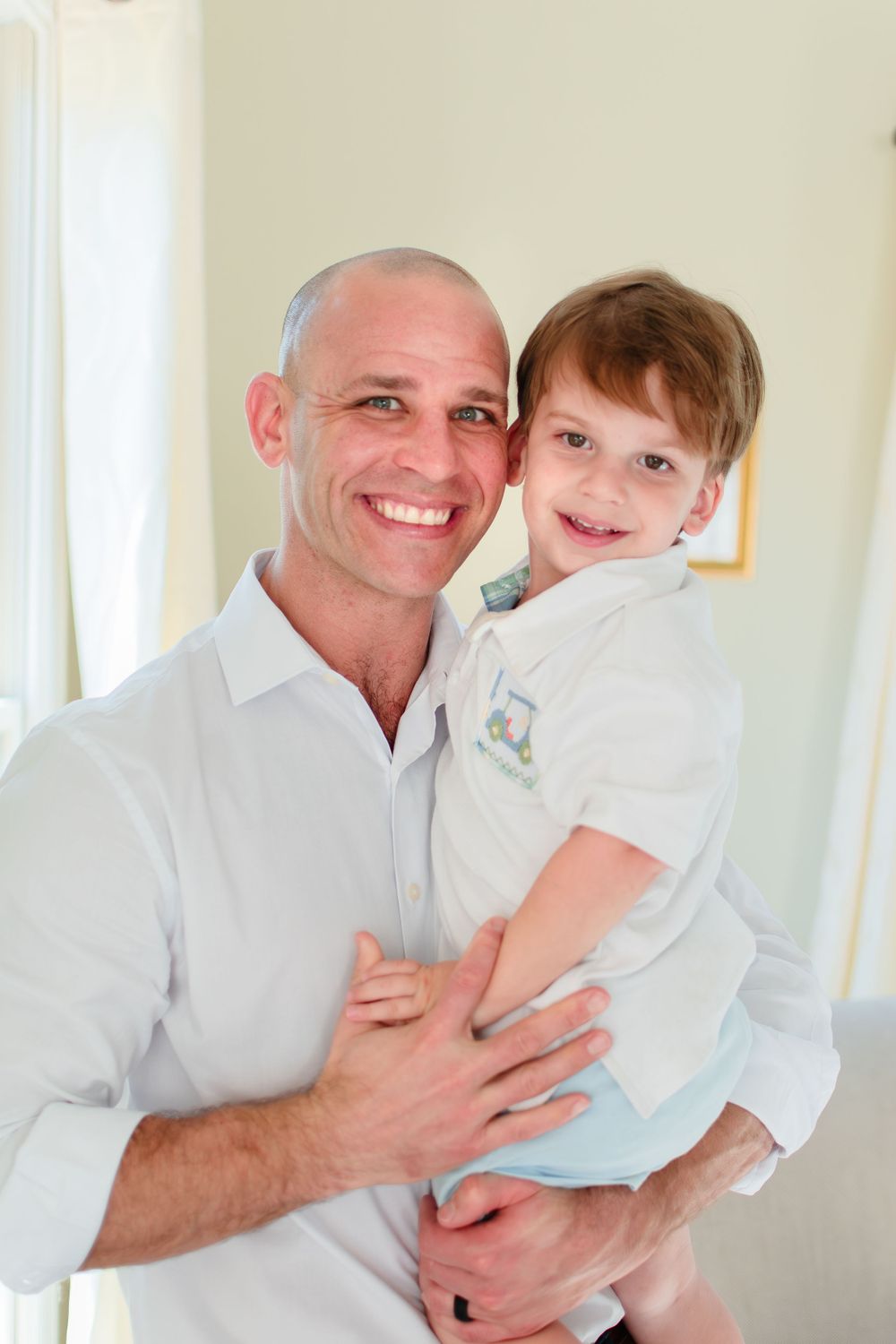 Dad and son smile for a photo.