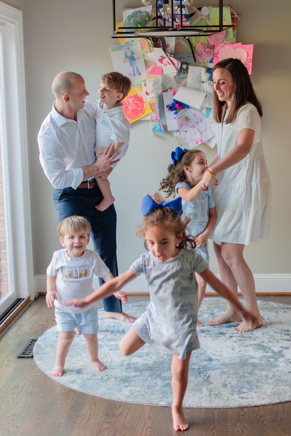 The entire family joins in an impromptu dance party in the kitchen.
