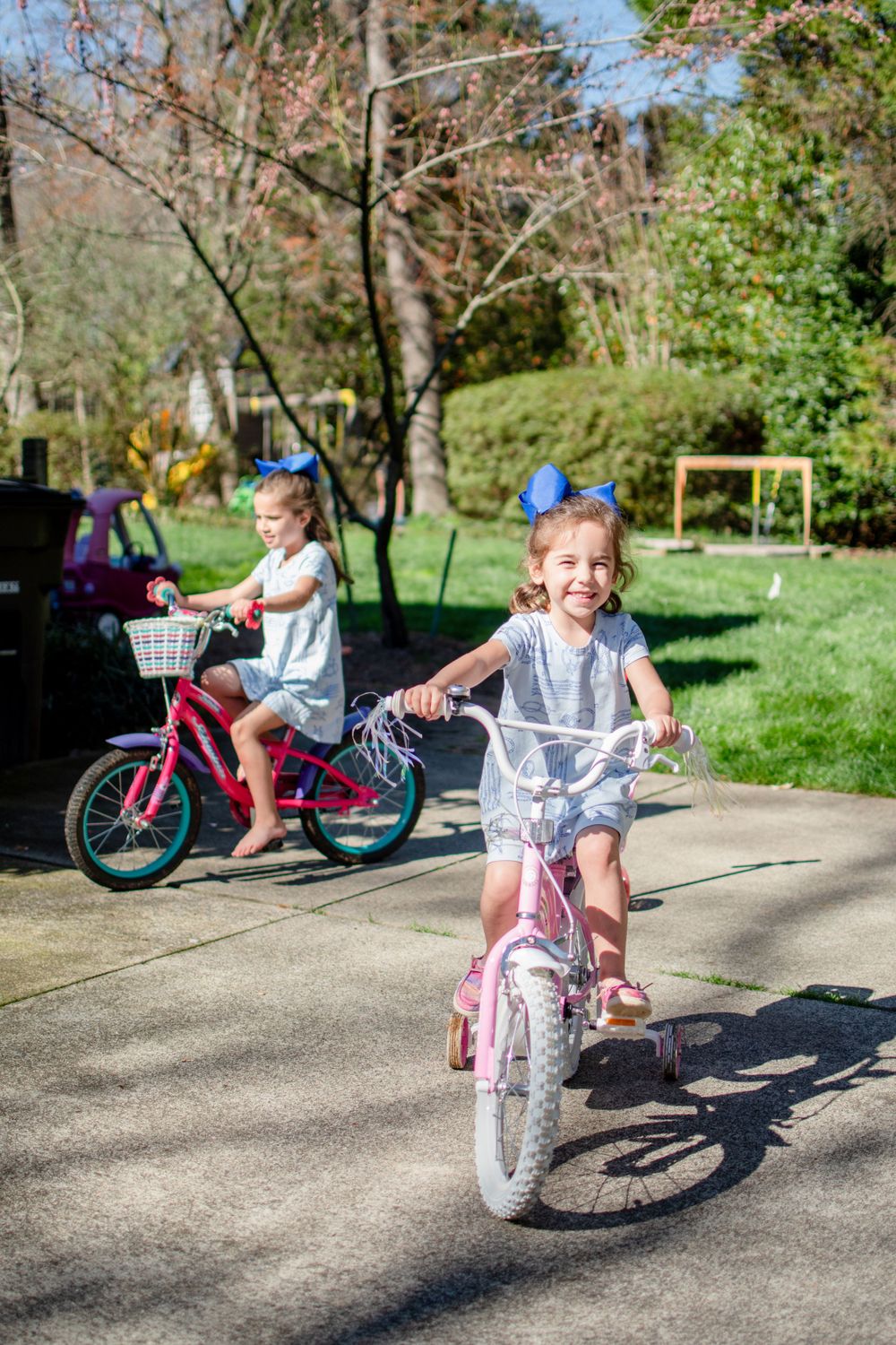 Two sisters are joyfully riding bikes outside their Winston-Salem home.