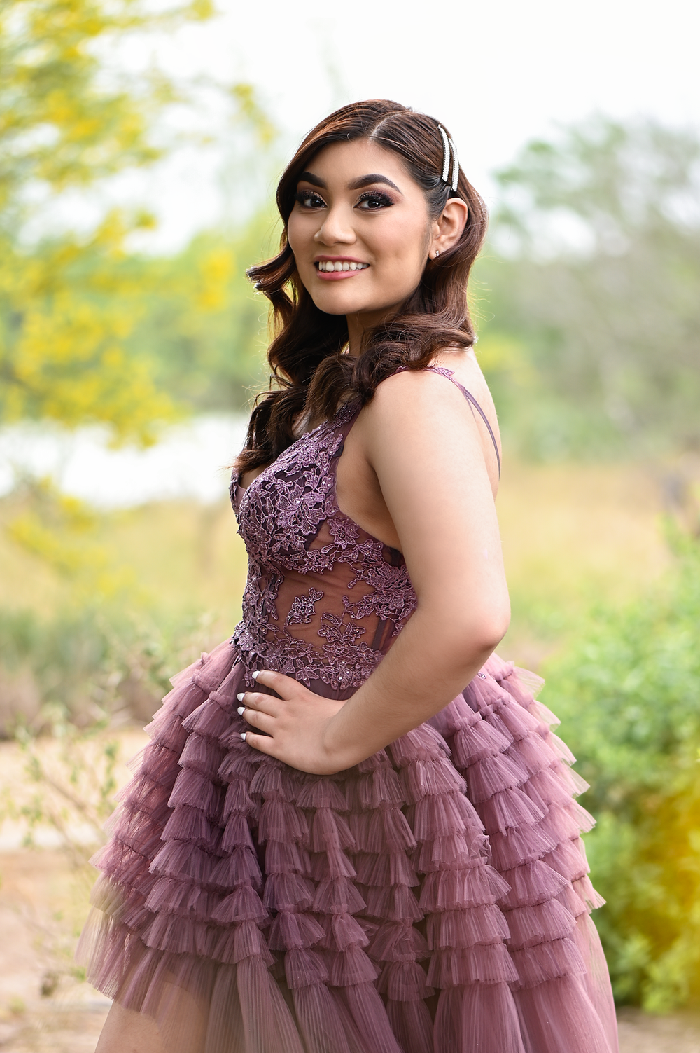 High-low mauve dress with ruffled layers and lace bodice in outdoor setting.