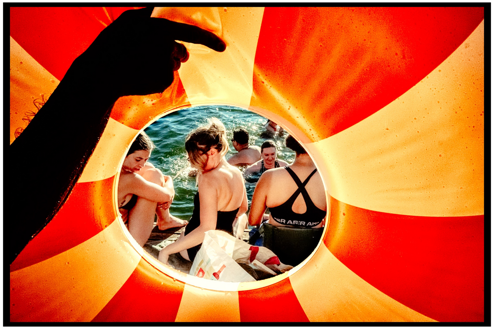 Artistic photo composition with circular frame and radiating orange sunburst background. Willamette River, Portland, OR