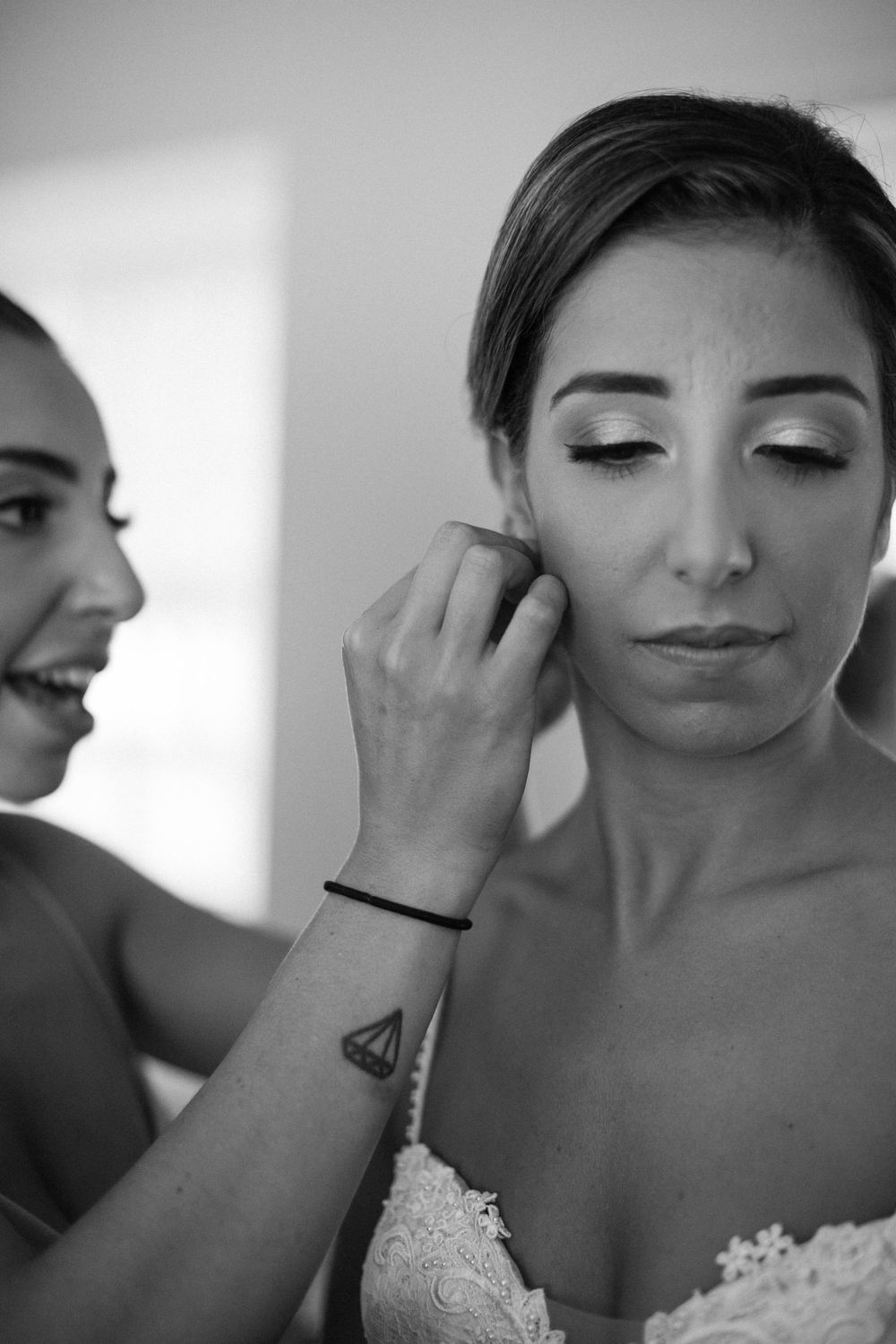 Close-up shot of bride getting her makeup done during wedding preparations.
