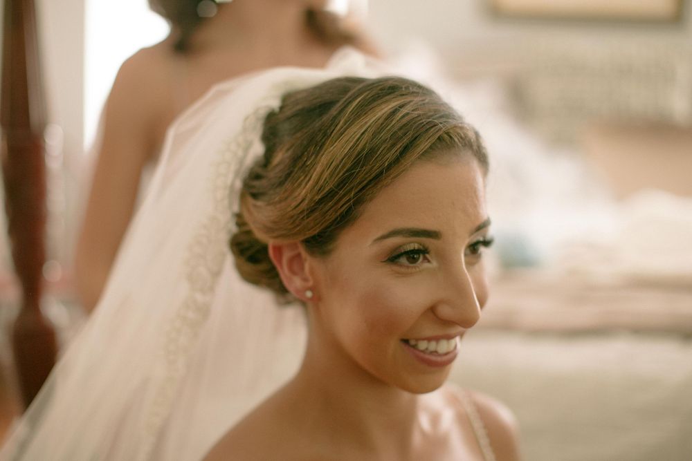Side profile of bride with elegant updo hairstyle and veil.
