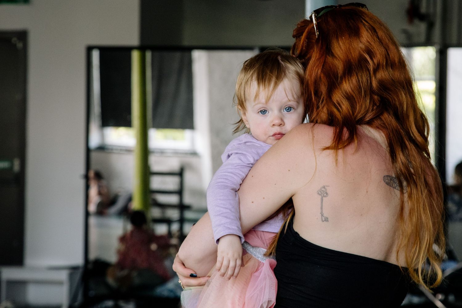 Parent and child sharing an intimate moment during a community gathering.