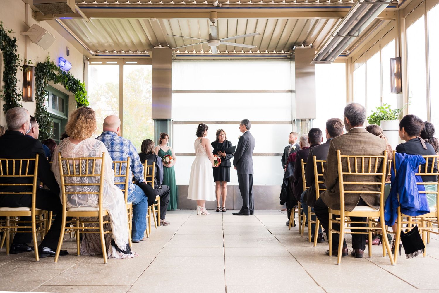 Wedding ceremony in a floor to ceiling window lit room atop Hotel Andaluz in Albuquerque, New Mexico