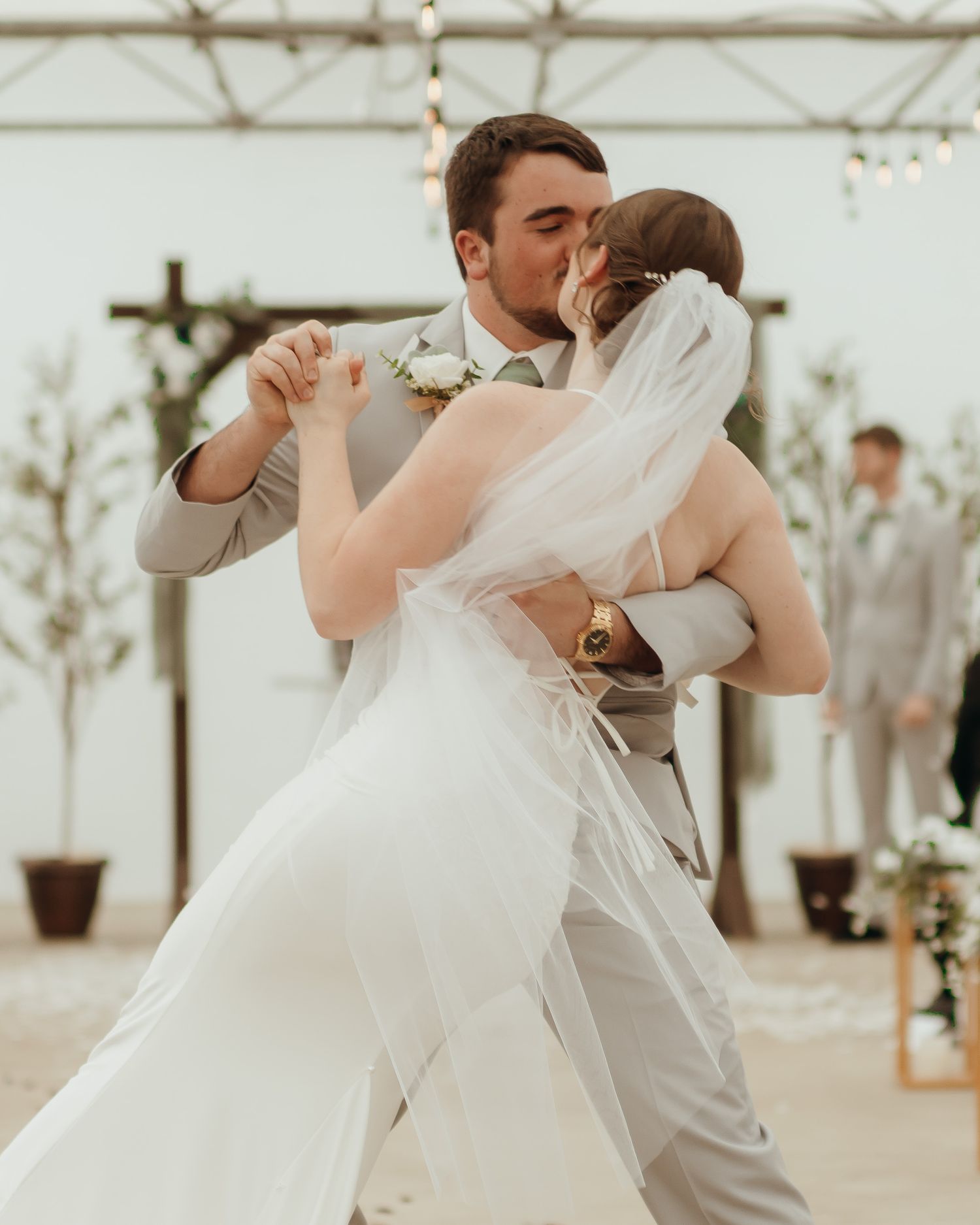 Passionate, sweeping kiss between the bride and groom
