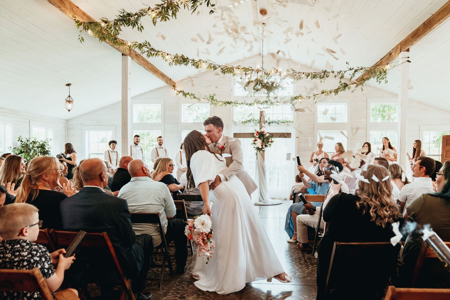 Bride and Groom Ceremony Exit Dip and Kiss. Beautiful Wedding Venue. Pink Wedding Flowers. Beautiful Wedding Dress and Shoes.