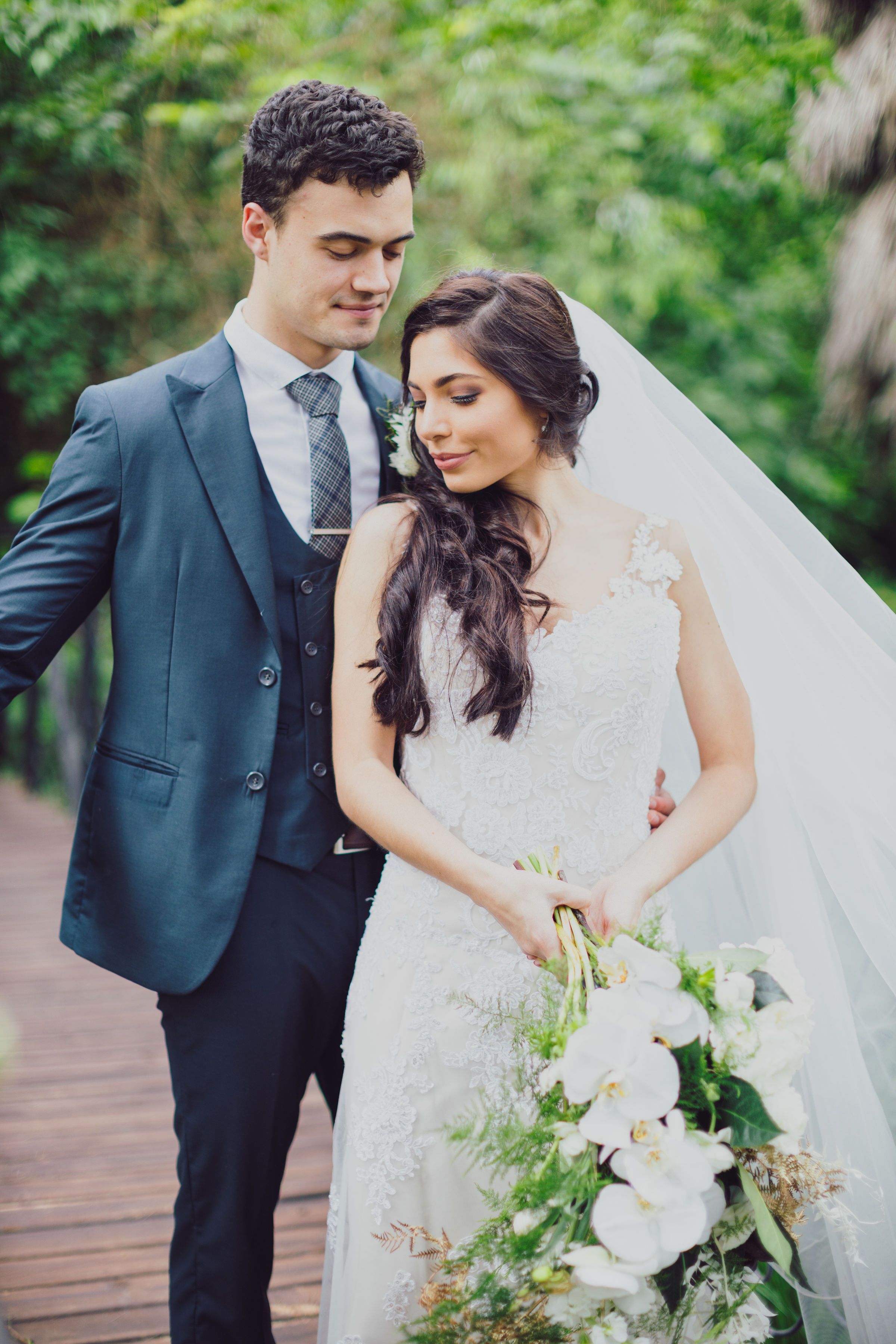 Bride and groom walking hand in hand through a rose garden after the ceremony