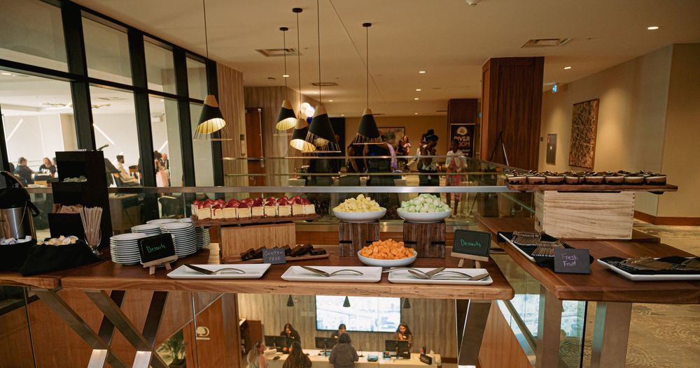 Elegant banquet hall setup with buffet stations and modern interior design.
