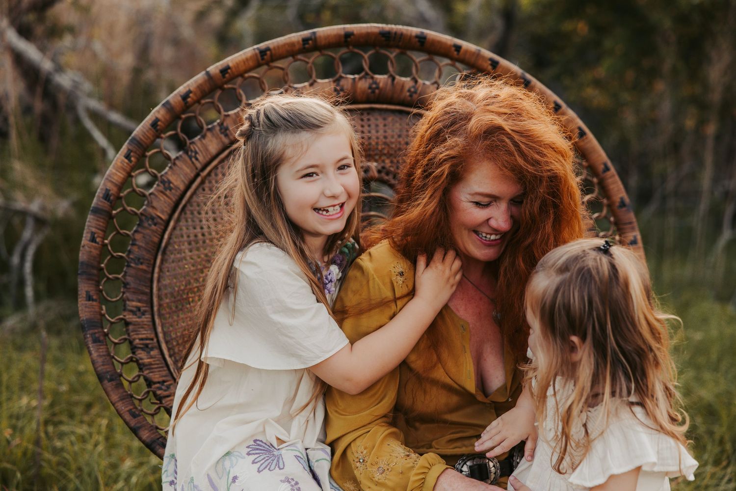 Playful outdoor gathering on a woven blanket during sunset.
