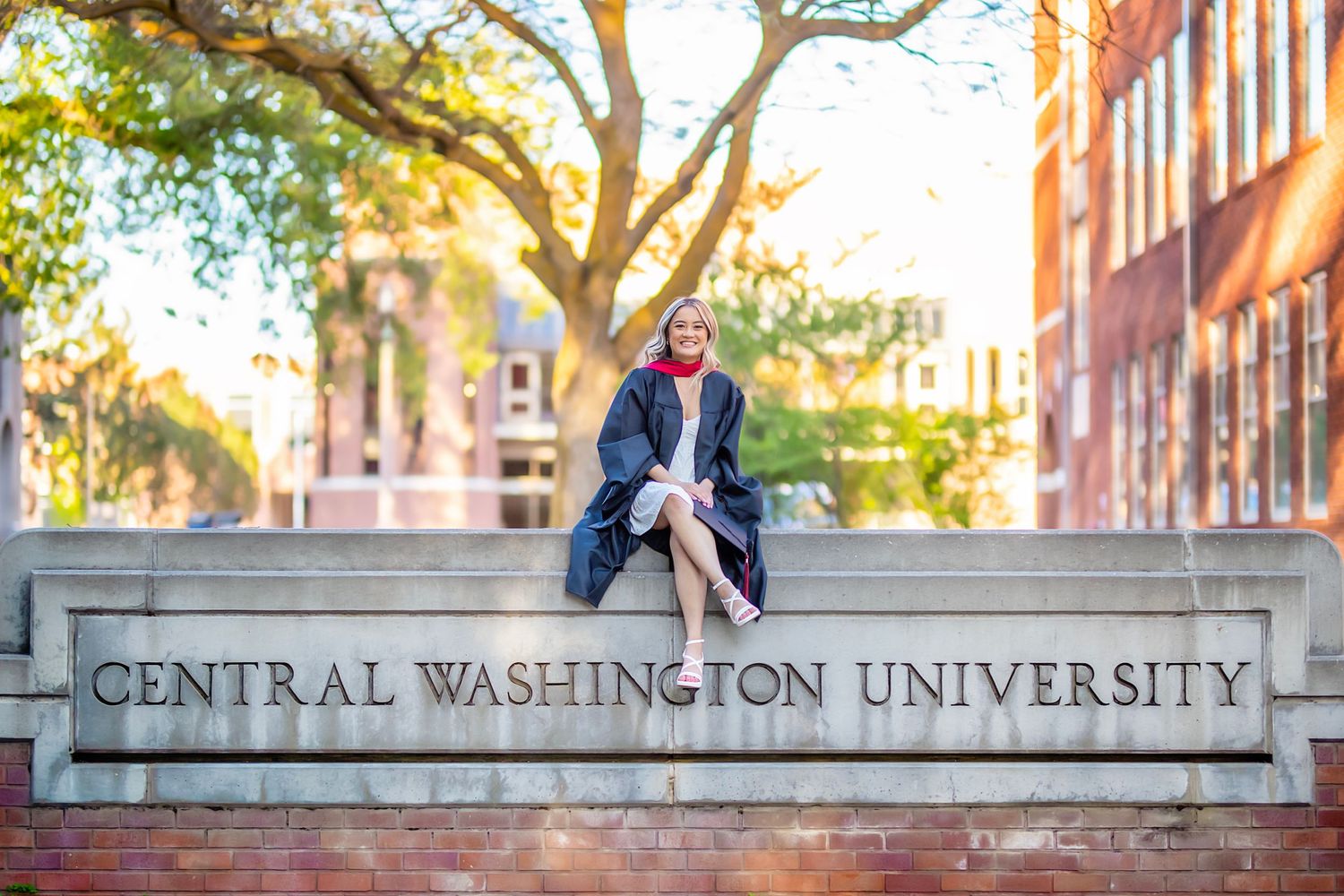 Central Washington University graduate poses at the university in Ellensburg, WA for her senior graduation photography session.
