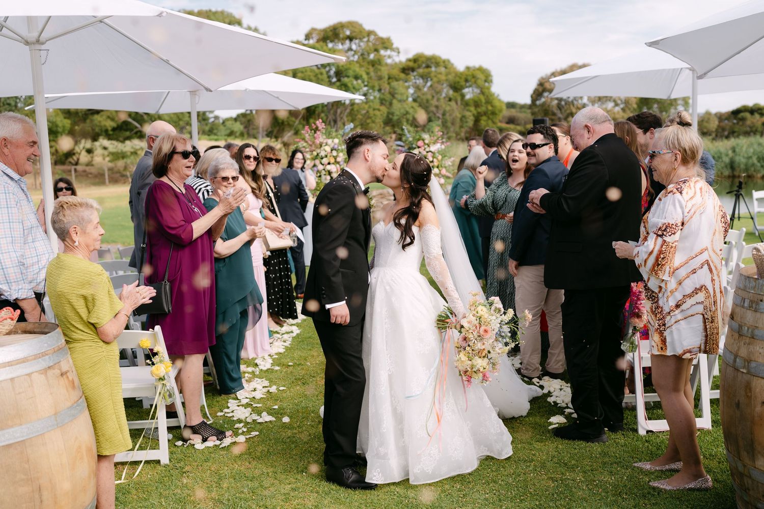 Erin and James celebrating their wedding at Lloyd Brothers vineyard, sharing a romantic moment surrounded by warm light and natural scenery
